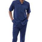 Side view of a male model wearing the navy short sleeve walking suit and matching trousers.