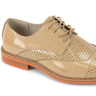 Close-up of tan leather cap-toe and intricate laser-cut perforated pattern.