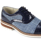 Close-up of sapphire blue leather brogue detailing and textured blue patterned tweed fabric