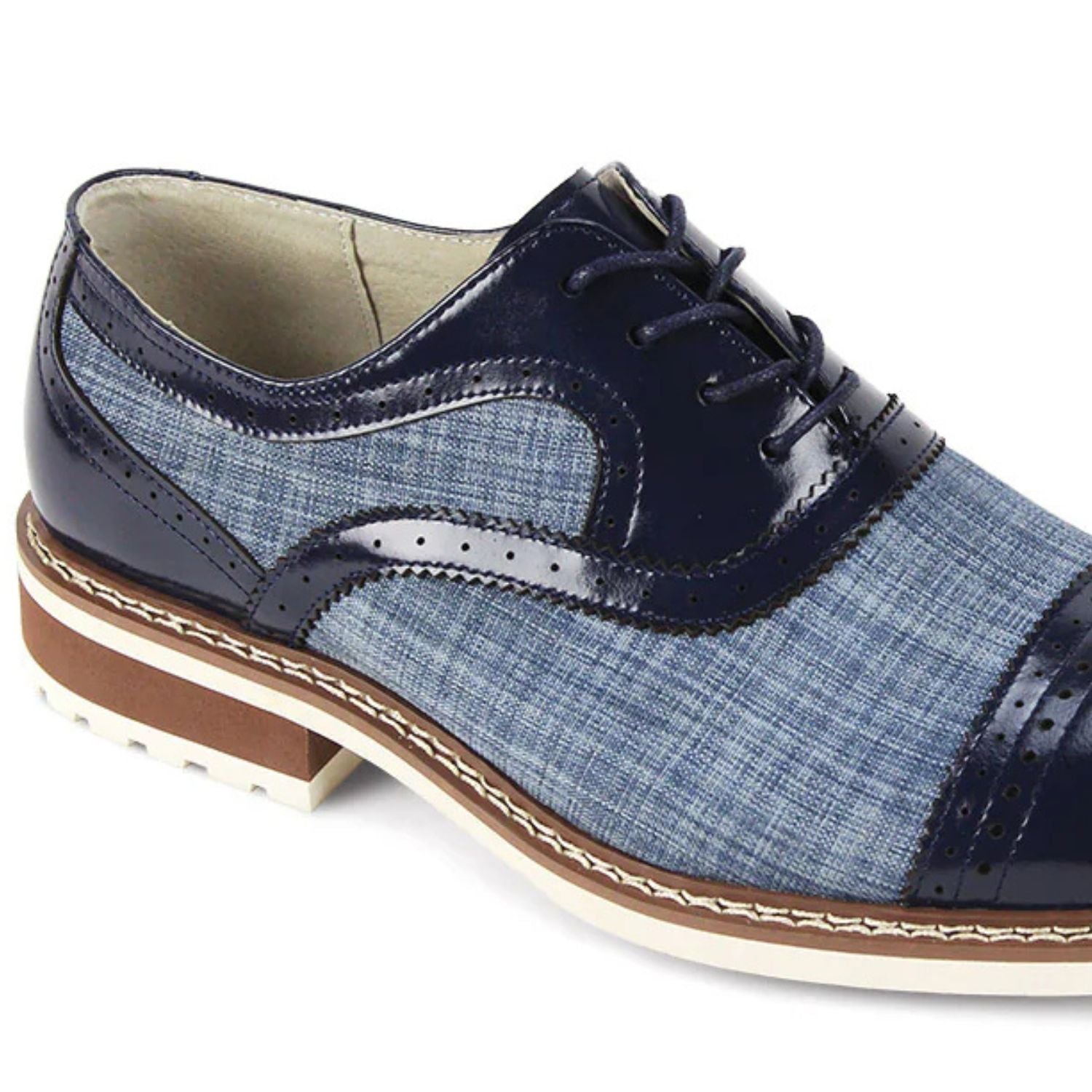 Close-up of sapphire blue leather brogue detailing and textured blue patterned tweed fabric