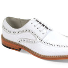 Close-up of white embossed coco-print leather texture and moc-toe stitching detail.