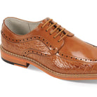 Close-up of tan leather dress shoe showcasing coco print texture and moc toe construction