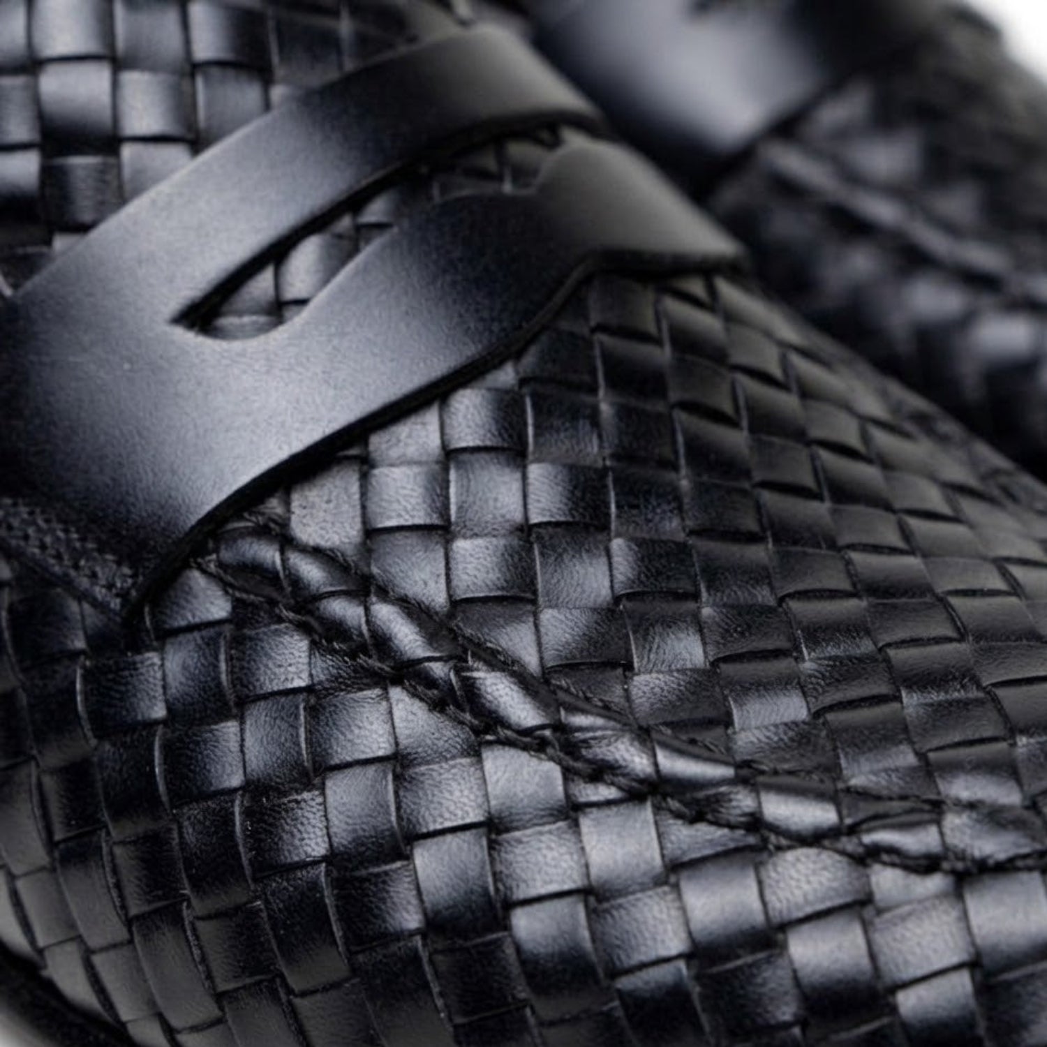 Close-up of the black handwoven calfskin penny loafers