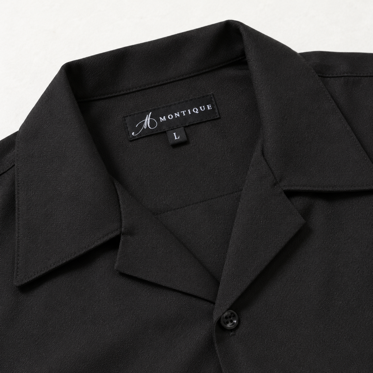 Montique black solid walking suit open collar and montique label detail