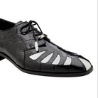Angled view of black and white alligator spectator shoe