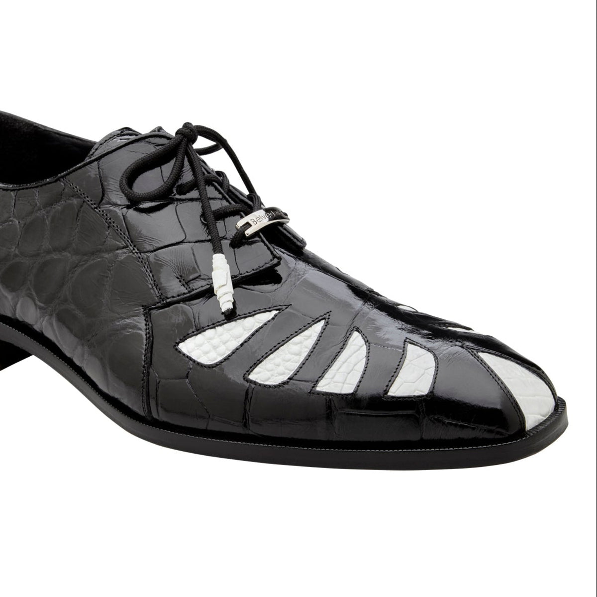 Angled view of black and white alligator spectator shoe