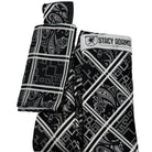 Close-up of the bold grid layout and intricate black and white paisley-geometric pattern on the Stacy Adams tie.