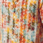 Close-up of the white shirt showing the abstract print and textured linen blend fabric.